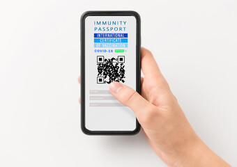 coronavirus, technology and health concept - close up of woman's hand holding and showing smartphone with international certificate of covid-19 vaccination on screen over white background