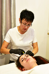 Treatment of baldness with beauty injections. Cosmetologist hands in gloves make a subcutaneous injection. Plasmalifting