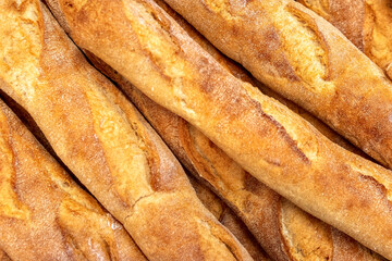 French baguettes in bakery close-up. Selective focus. Fresh bread and baguettes background.