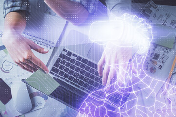 Double exposure of man and woman working together and man in virtual glasses hologram drawing. Computer background. Top View. VR, AR concept.