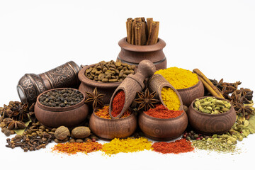 An assortment of spices, coffee and seasoning, in wooden bowls, isolated on a white background.