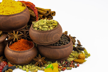 Spices, sweets in wooden bowls isolated on white background, free space for text.