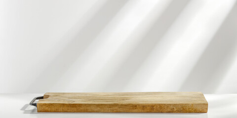 Wooden pedestal of free space for your decoration and wall with shadows. 