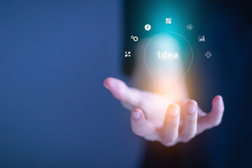 Hand holding illuminated light bulb, idea and imagination, business, creative, innovation inspiration concept.