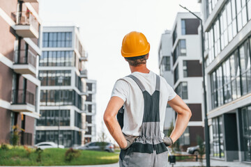 This is the future. Young man working in uniform at construction at daytime