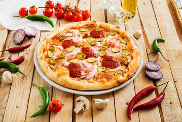 tasty pizza on the wooden background