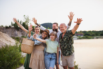 Happy multigeneration family on hiking trip on summer holiday, taking selfie.
