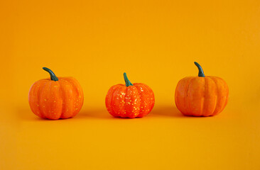 Pumpkins on an orange background. Copy space. Background for design.