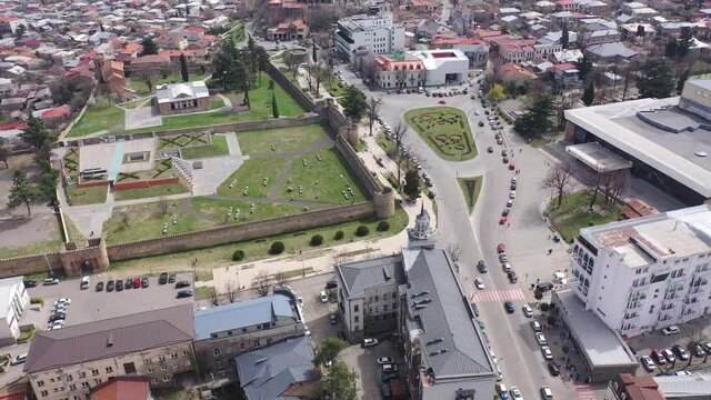 Scenic view from drone of central areas of Telavi city overlooking medieval walled Batonis Tsikhe fortress on spring day, Georgia