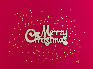 Merry Christmas gold greeting message and golden stars confetti on red background