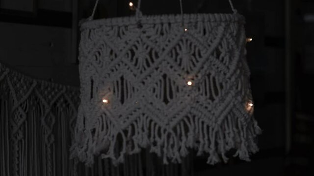 handmade macrame lampshades hanging open design in natural colours.boho style shell shade For a lamp. on black background. Close up video. Slow motion video. stock footage.