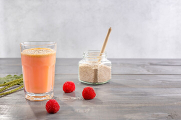 a glass of smoothies made from rubus illecebrosus berries and coconut milk with psyllium seed husks. the concept of healthy food