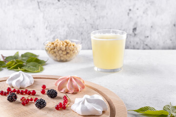 Vegan meringue, boiled chickpeas, aquafaba, red currants and blackberries. The concept of vegan cuisine. A useful product. . Selective focus.