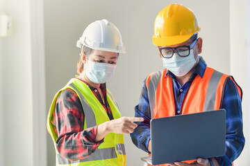 Civil construction engineer working with laptop at desk office on construction site.