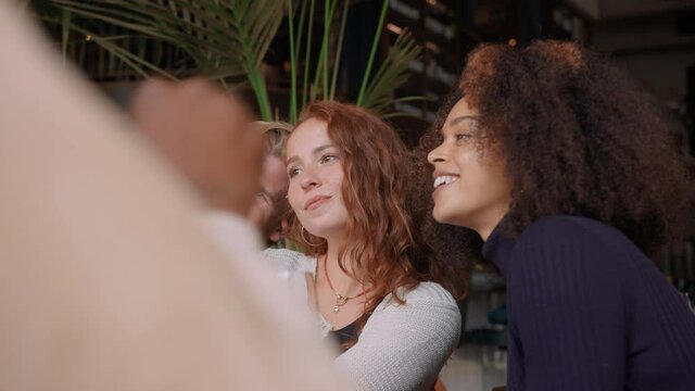 Slow motion of friends taking selfie in bar