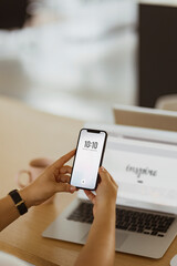 A man checking date and time on a phone