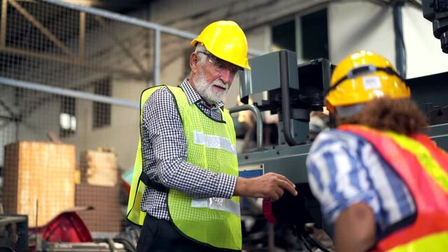 Male and female Industry engineer team in safety helmet working together in recycle electronic part factory. Woman foreman introduce factory department to senior manager. Machinery industrial concept