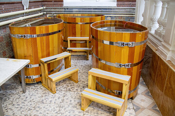Western style wooden bathtubs in barrel shape. Spa treatments barrels cedar bath in wooden...