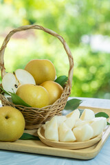 Fresh Snow pear fruit in Bamboo basket on blurred greenery background, Fresh pear fruit in the basket on natural farm.