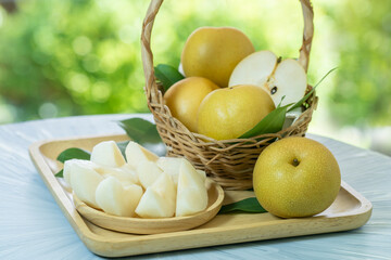 Fresh Snow pear fruit in Bamboo basket on blurred greenery background, Fresh pear fruit in the basket on natural farm.