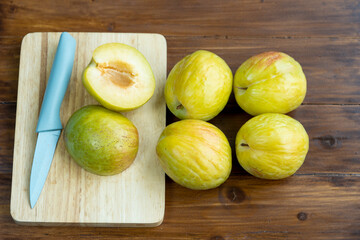  Fresh Green plum or Flavor Grenade Pluot , Green plum on wooden table in garden.