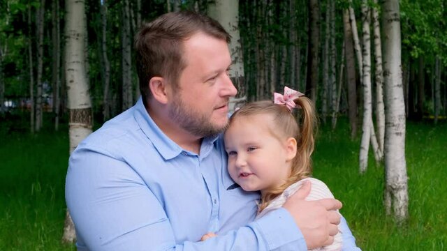 strong dad gently hugs his little daughter, 3 years old, enjoying fatherhood. Fathers day. Happy childhood and parenting concept. Child protection