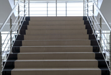 Staircase up against the background of large windows