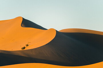 The sunset view of the dunes in deserts in Dunhuang, China.