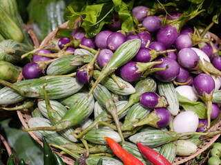 Assorted eggplants available over the counter in the market.