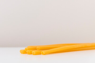 Eco-friendly pasta straws on light background with copy space