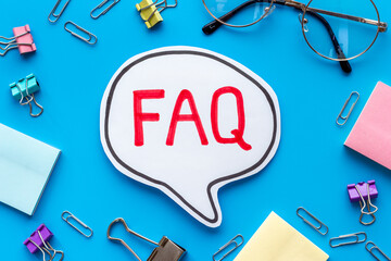 Word faq frequently asked questions with stationery on working place