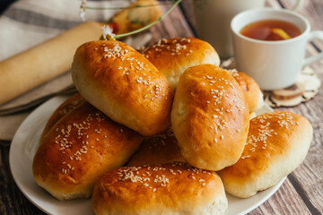 Pies with onions and eggs. Russian national dish. Delicious pies on a wooden table 