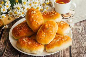 Pies with onions and eggs. Russian national dish. Delicious pies on a wooden table 