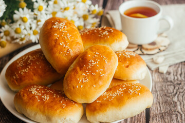 Pies with onions and eggs. Russian national dish. Delicious pies on a wooden table 