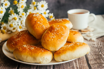 Pies with onions and eggs. Russian national dish. Delicious pies on a wooden table 