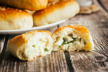 Pies with onions and eggs. Russian national dish. Delicious pies on a wooden table 