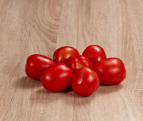 Tomatoes on wooden background. Soft light. Nobody