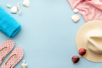 Fototapeta na wymiar Frame of beach accessories with sraw hat, sunglasses and flip flops