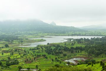 View of Tringalwadi irrigation dam backwaters and fields, Nashik, Maharashtra, India.