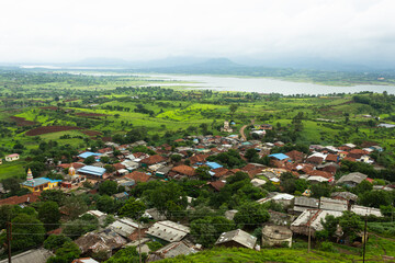 Kavnaai village from Kavnai Fort Nashik, Maharashtra, India. Fort was built by Moghuls. It was ceded to Peshvas by Nizam under the terms of the treaty after the Battle of Udgir 1760. - obrazy, fototapety, plakaty