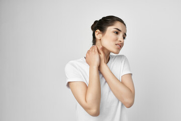 Woman in white t-shirt neck pain treatment health problem