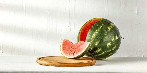 Wooden desk with pedestal for your decoration and fresh watermelon 