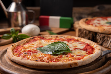 Pizza margarita topped with fresh basil leaves