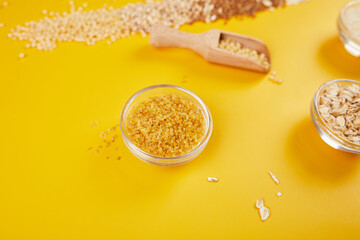 Flat lay of set of heap various grains and cereals on yellow background