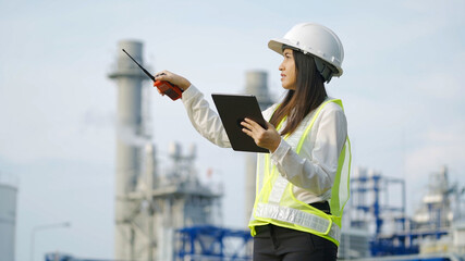 Industrial engineer using digital tablet for work against the electrical plant
