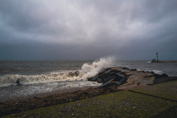 Stormy sea waves splashing to the jetty on Cape Cod beach