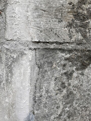 part of an old wall built of stone blocks and firmly bonded with cement