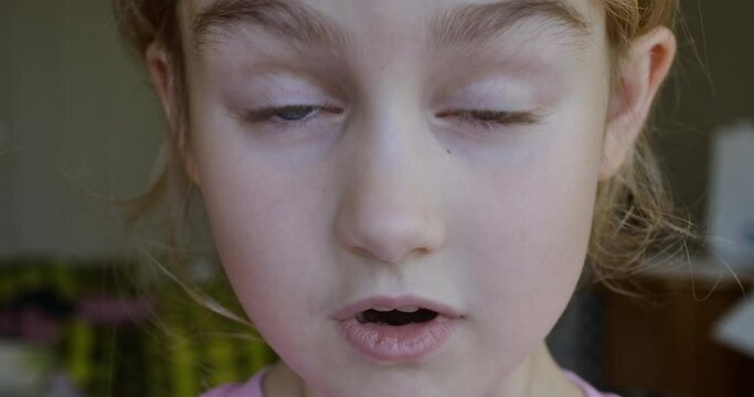 Child Girl Looks and Is Surprised Happy to Receive Surprise. Portrait Little Kid With Blue Eyes Looking at Camera Closeup. Surprised Girl Face. Close up of Shocked Child Face Expression. Wow Emotion.