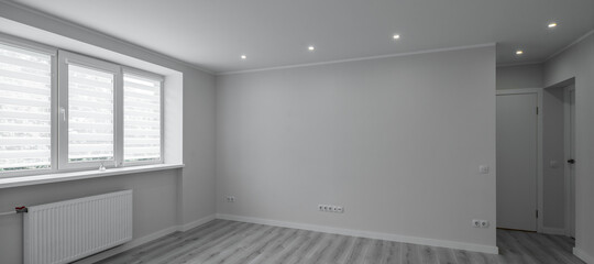 Contemporary interior of empty room. Apartment after renovation. Parquet floor. Black and white.