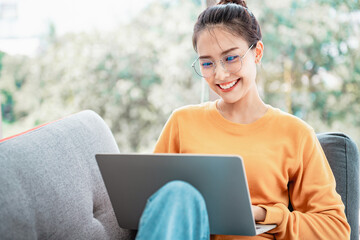 Happy asian woman browsing work opportunities online, She using job search in website on laptop, copy space